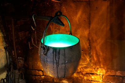 Bubbling, glowing cauldron with projected fire effect
