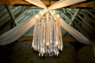 White chandelier with pastel ribbons